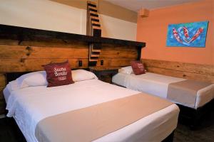 Postel nebo postele na pokoji v ubytování Casa Bonita Hotel y Hostal
