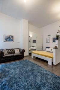a bedroom with a bed and a couch at Stylish Downtown Studio in Budapest
