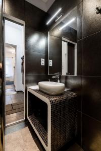 a bathroom with a sink and a mirror at Stylish Downtown Studio in Budapest