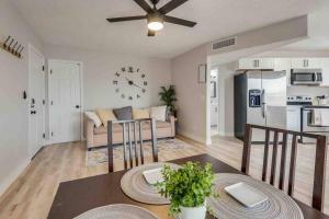 a living room with a table and a clock on the wall at Cozy home! 16 Min away from strip and fremont in Las Vegas