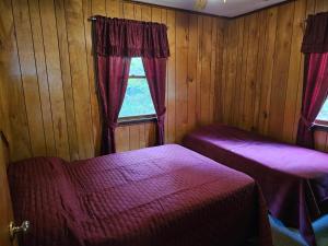 a room with two beds and a window at The Gold Eagle in Lake George