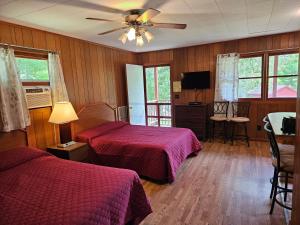 a hotel room with two beds and a ceiling fan at The Gold Eagle in Lake George