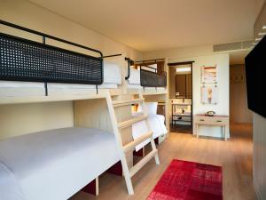 Ce dortoir comprend des lits superposés et une salle de bains. dans l'établissement Moxy Seoul Myeongdong, à Séoul