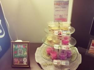 a tiered tray of cupcakes on a plate with signs on it at HOTEL WILL渋谷 LOVE HOTEL -Adult only- in Tokyo