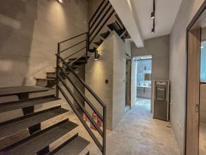 a metal staircase in a room with a hallway at hsueh_house in Yilan City