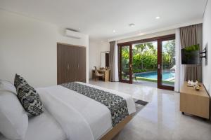 a bedroom with a large bed and a pool at Villa UmaDahayu in Sanur +38 photos