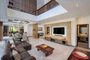 a living room with a couch and a table at Villa UmaDahayu in Sanur