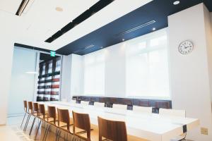 a large conference room with a long table and chairs at Quintessa Hotel Kokura Comic & Books in Kitakyushu