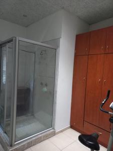 a bathroom with a glass shower in a room at camila guest house in Rundu