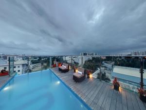 a large swimming pool on the roof of a building at Svenska Design Hotel, Electronic City, Bangalore in Bangalore