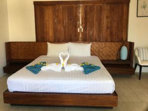 a bedroom with a bed with two towels on it at Bangpo Village in Ban Bang Po
