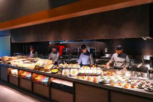 a group of chefs preparing food in a kitchen at TAOYA Akiu in Sendai