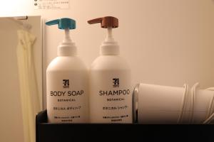 two bottles of baby soap and a roll of toilet paper at 桜の宿 in Osaka
