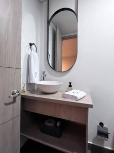 a bathroom with a sink and a mirror at Parallelo Loft Salento P3 in Salento