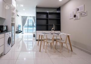 a kitchen and dining room with a table and chairs at Atria Sofo Suites - Petaling Jaya in Petaling Jaya
