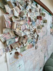 a wall with lots of money on it at Tunduk Hostel in Bishkek