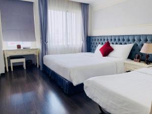 Luxury Old Quarter Hotel & Gym tesisinde bir odada yatak veya yataklar