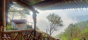 a view from the porch of a house with a view of a mountain at IYAMAN FARM near SAGADA 