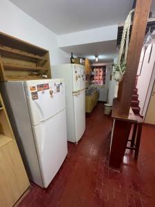 a kitchen with two refrigerators and a refrigerator at Comoda y amplia casa en Mercedes BsAs in Mercedes