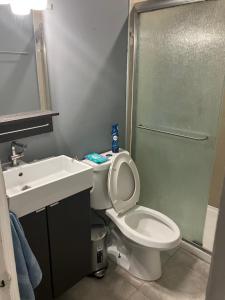 a bathroom with a toilet and a sink and a shower at Hollywood Beach 3 Bedroom Apartment in Hollywood