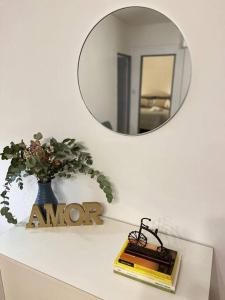 a mirror on a shelf with a book and a vase at Departamento 2 amb - Palermo - desc estadía larga in Buenos Aires