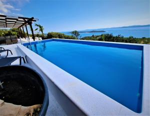 a large swimming pool with a blue pool at Villa Robinson in Tkon +43 photos