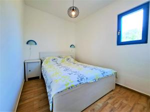 a small bedroom with a bed and a window at Villa Robinson in Tkon