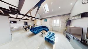 a large room with blue chairs and a projection screen at Luxury house David with heated pool, jacuzzi and sauna in Nerežišće