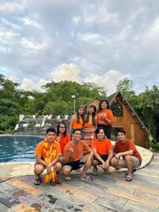 a group of people posing for a picture in front of a house at Don Roberto's Kubo Resort in Nasugbu