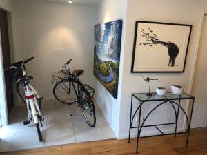 a room with two bikes parked next to a table at Absolute waterfront in Raglan