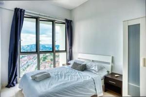 a bedroom with a bed and a large window at Tropics Condo in Petaling Jaya +139 photos