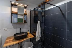 a bathroom with a sink and a mirror at Green house in Dograde