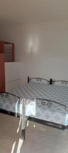 a bed sitting in a room with at La Perla nel Blu in Villasimius