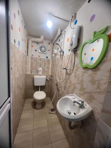 a bathroom with a toilet and a sink at Country house Pulai Holiday Village in Gua Musang +129 photos