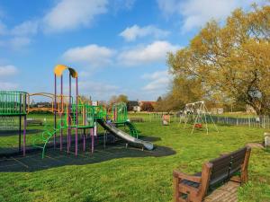 a playground with a slide in a park at Seascape Cottage in South Creake