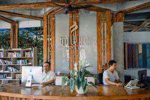 three men sitting at a table with their computers at Baleka Resort & Spa in Legian