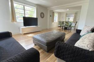 a living room with two couches and a flat screen tv at Lively Home near Downtown, stadium, Wynwood in Miami