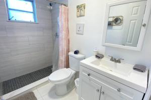 a bathroom with a toilet and a sink and a shower at Lively Home near Downtown, stadium, Wynwood in Miami +38 photos
