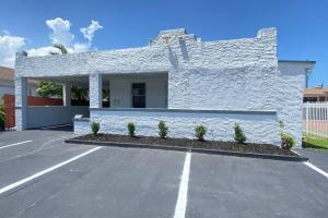 a white building with a parking lot at Lively Home near Downtown, stadium, Wynwood in Miami