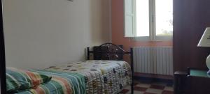 a bedroom with a bed in a room with a window at Casa LOLU in Ortona