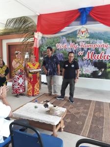 a group of people standing in front of a table at Mulu Helena Homestay in Mulu