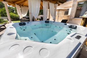 eine Whirlpool-Badewanne auf einer Terrasse in der Unterkunft Holiday Home Rajna in Pražnice