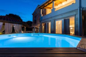 a swimming pool in front of a house at Holiday Home Rajna in Pražnice