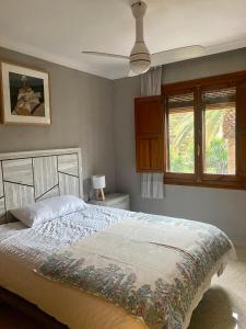 a bedroom with a large bed and a window at Charming Home in Lorca Murcia in Lorca