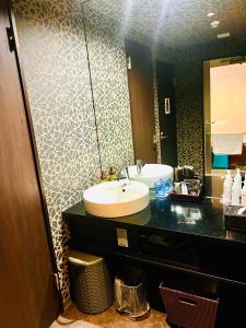 a bathroom with a sink and a mirror at Asokono Hotel in Kami-seya