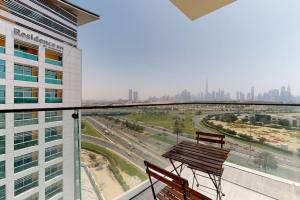 a balcony with two benches and a view of a city at O Ten Al Jaddaf - Locations in Dubai