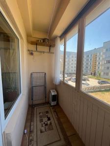 a room with a room with two windows and a heater at Atmodas 70 in Jelgava
