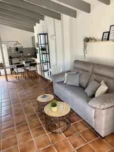 a living room with a couch and a table at Bungalow Tropical nº6 - Son Xoriguer in Son Xoriguer