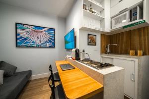 a kitchen with a wooden counter top in a room at Studio247 Experience by Haven in Brasilia