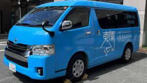 a blue van parked in a parking lot at Toyoko Inn Hakata-eki Minami in Fukuoka